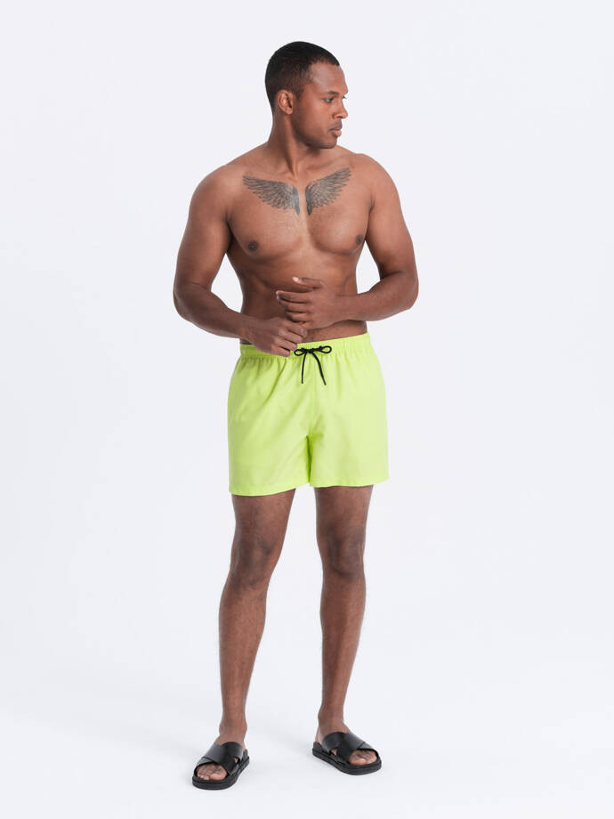 Neon men's swim shorts with magic print effect - lime green V1 OM-SRBS-0147