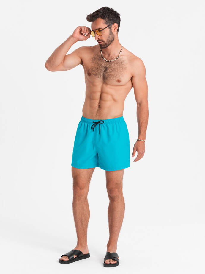 Neon men's swim shorts with magic print effect - turquoise V2 OM-SRBS-0147