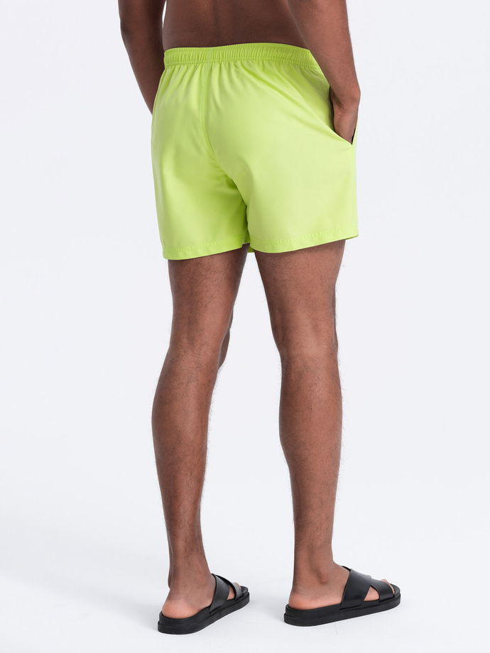 Neon men's swim shorts with magic print effect - lime green V1 OM-SRBS-0147