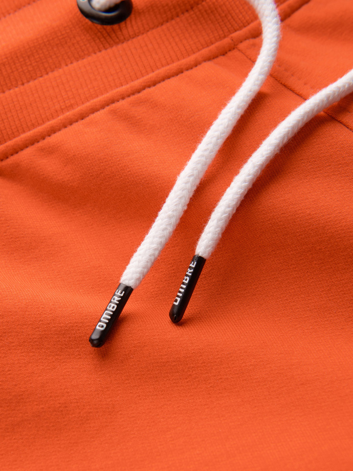 Pánské teplákové kraťasy se zakulacenými nohavicemi - oranžové V5 OM-SRSK-0105