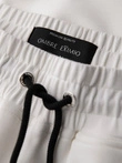 Men's sweatpants with ribbed legs and rubber print - white V2 OM-PASK-0223