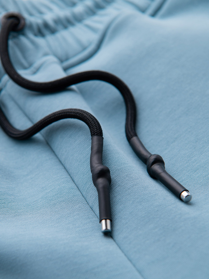 Pánske tepláky s rebrovanými manžetami a ozdobným zipsom - svetlomodré V4 OM-PASK-0226