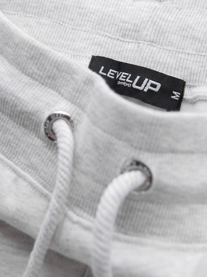 Pánske tepláky s lemovaním a rebrovaním na nohaviciach - sivý melír V1 OM-PASK-0258