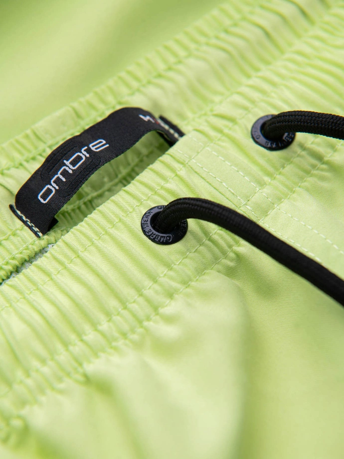 Neon men's swim shorts with magic print effect - lime green V1 OM-SRBS-0147