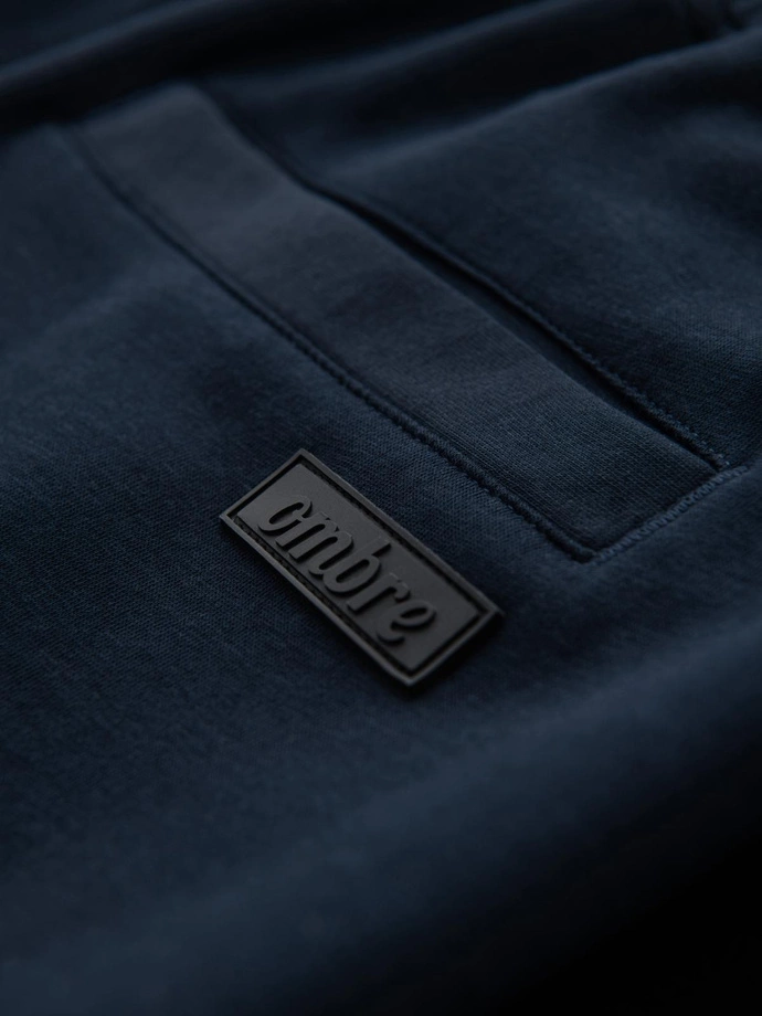 Pantaloni de trening pentru bărbați cu picior drept și detalii din cauciuc - albastru închis V2 OM-PASK-0281