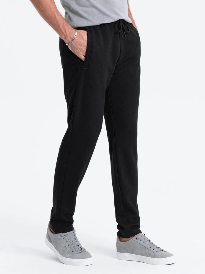 Pantaloni de trening bărbătești cu croială morcov - negru V1 OM-PASK-0166